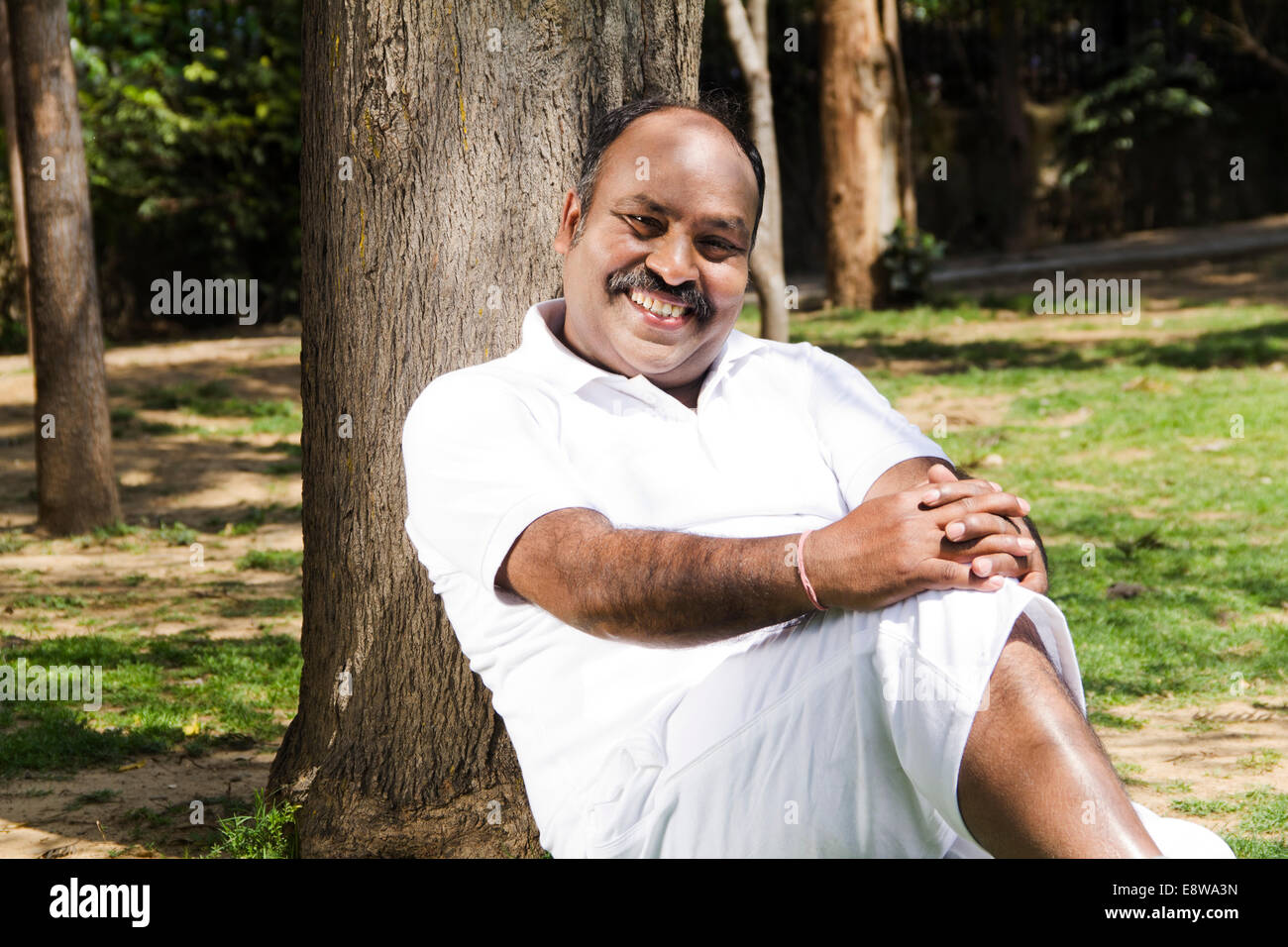 1 Indian Man Sitting in Park Stock Photo - Alamy