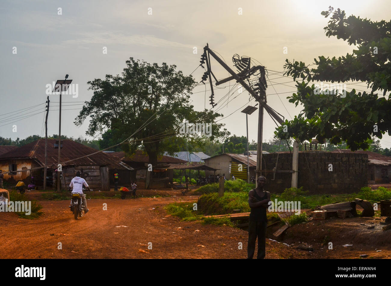 Rural Nigeria showing poor electrification and little access to energy, and a public lamp using a solar panel Stock Photo