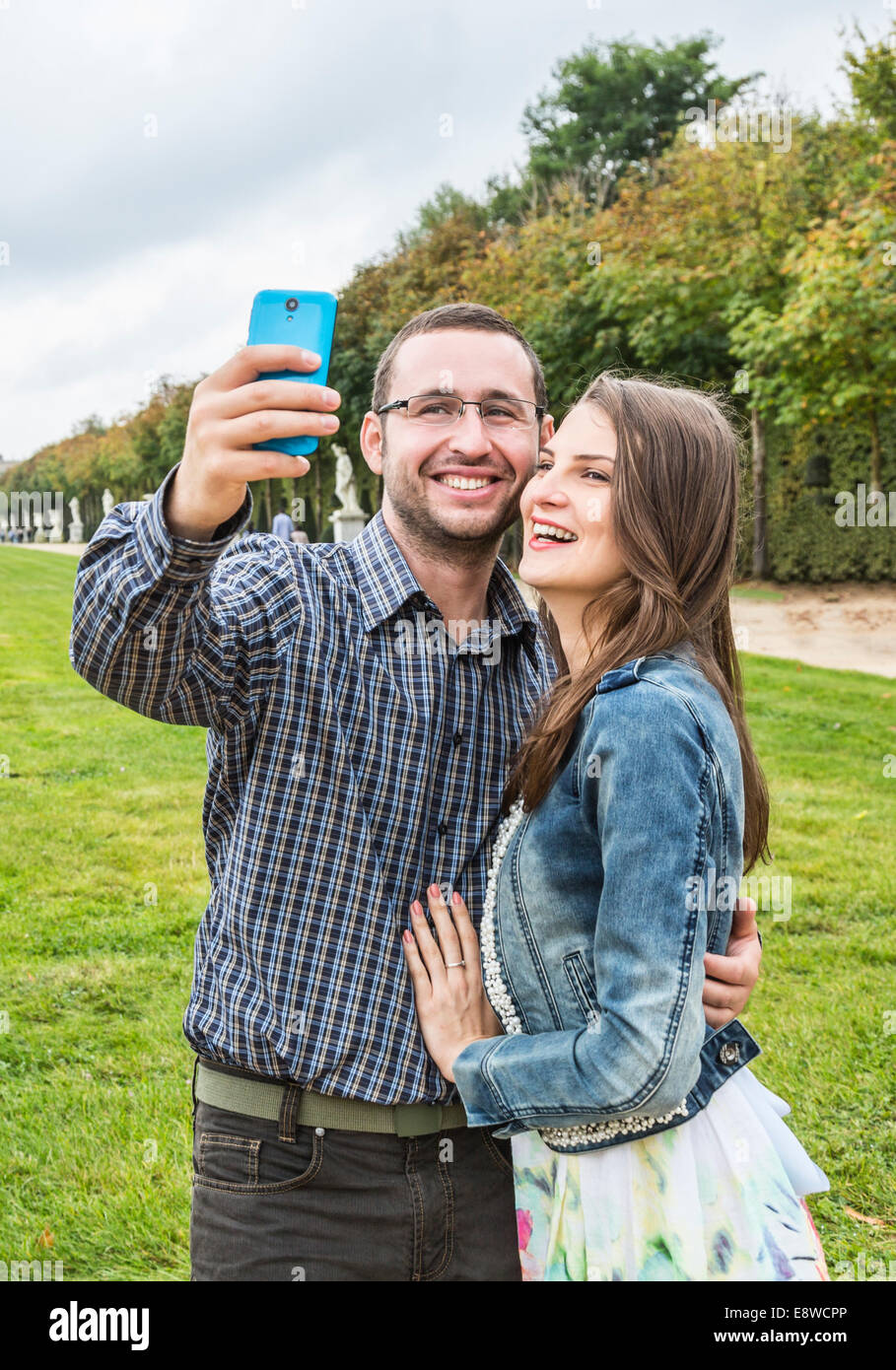 Young happy couple taking a selfie in a beautiful French garden Stock ...