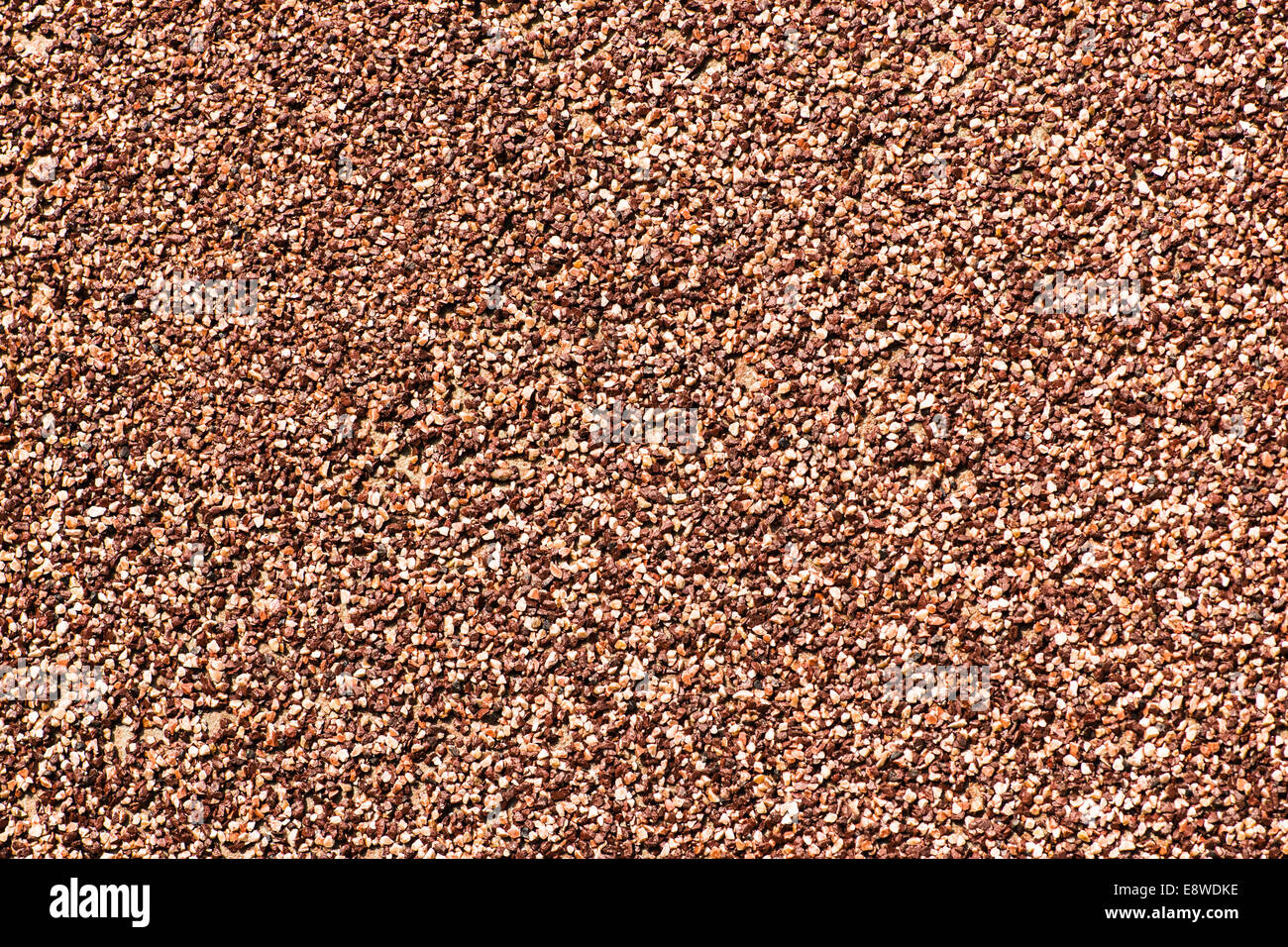 Coarse Grained Texture. Coarse grained texture of red and brown color. Coarse sand Stock Photo