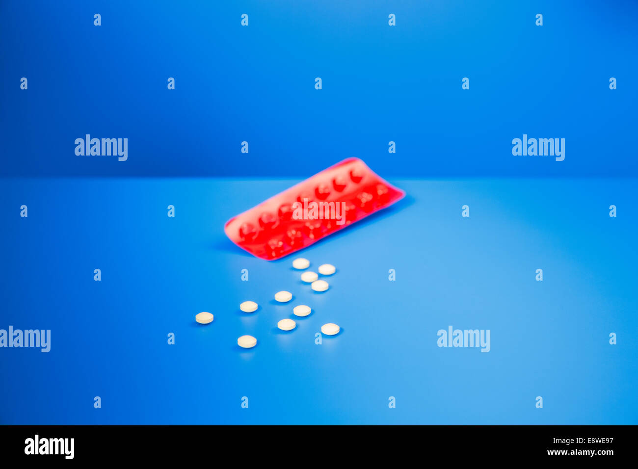 Prescription pills by blister pack on blue counter Stock Photo