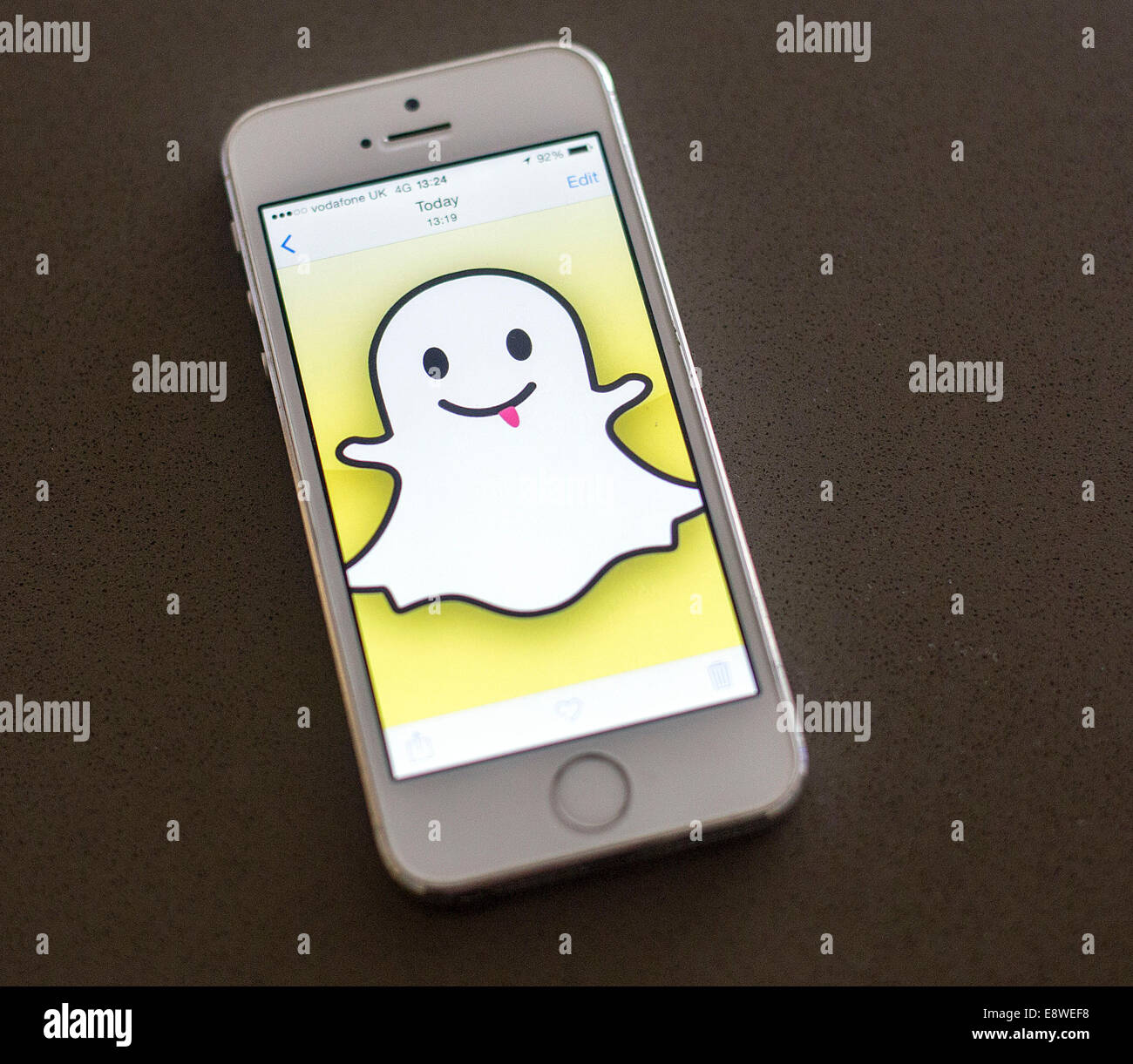 White Iphone 5s Snapchat app logo on screen Stock Photo