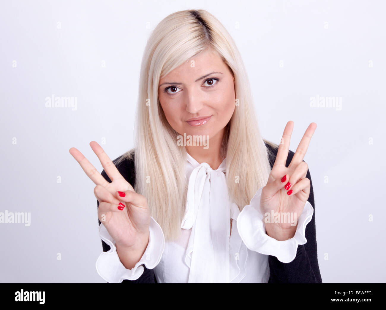 Female peace gesturing with hand, isolated on white Stock Photo