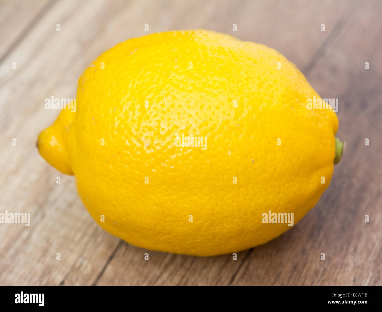 Whole Lemon On Wood Table Stock Photo