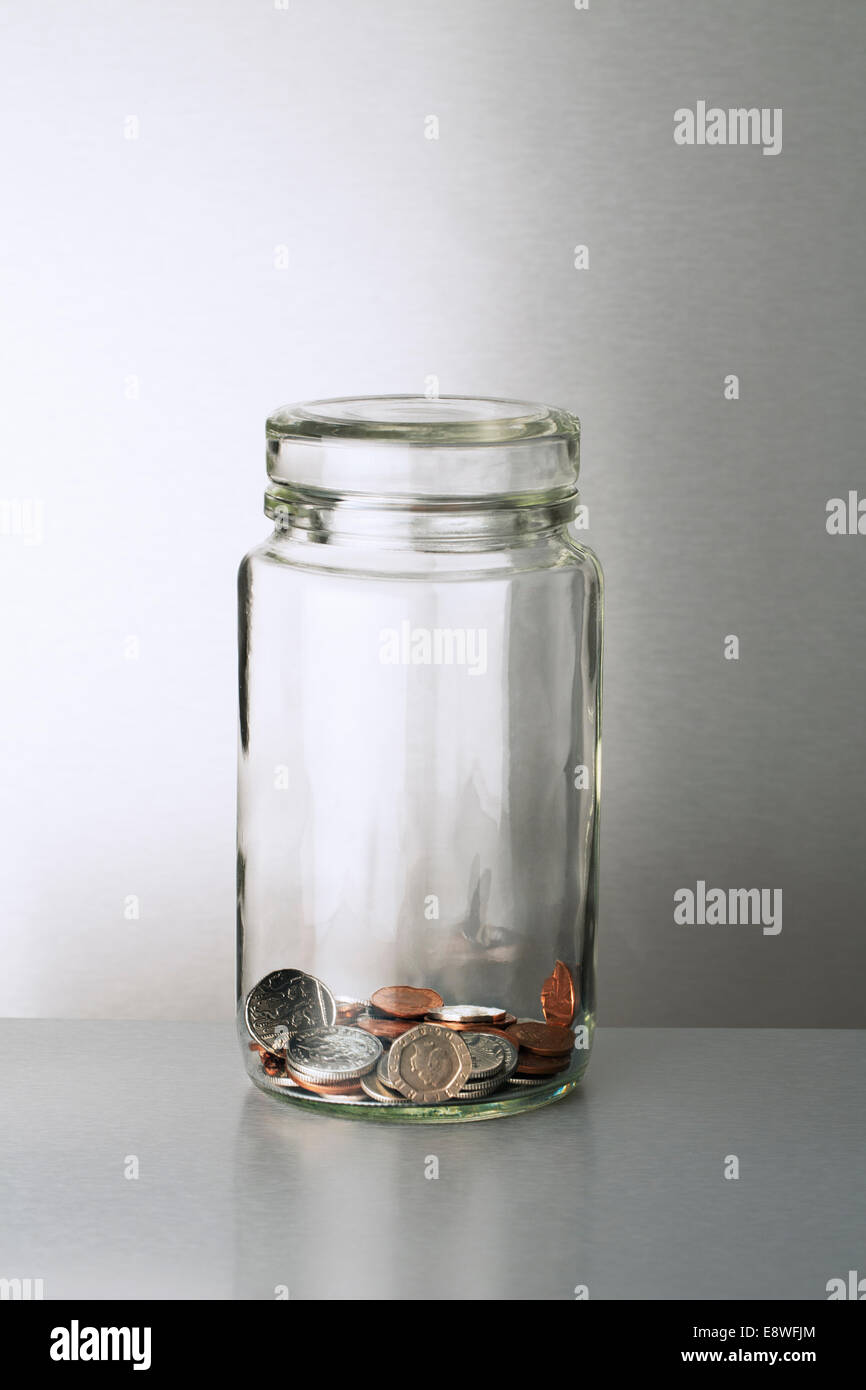 Glass change jar on counter Stock Photo