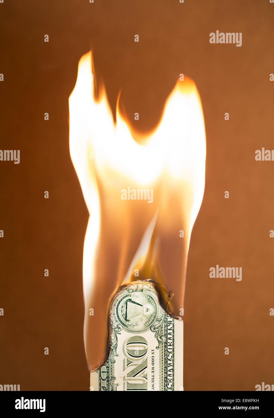 Folded dollar bill burning Stock Photo