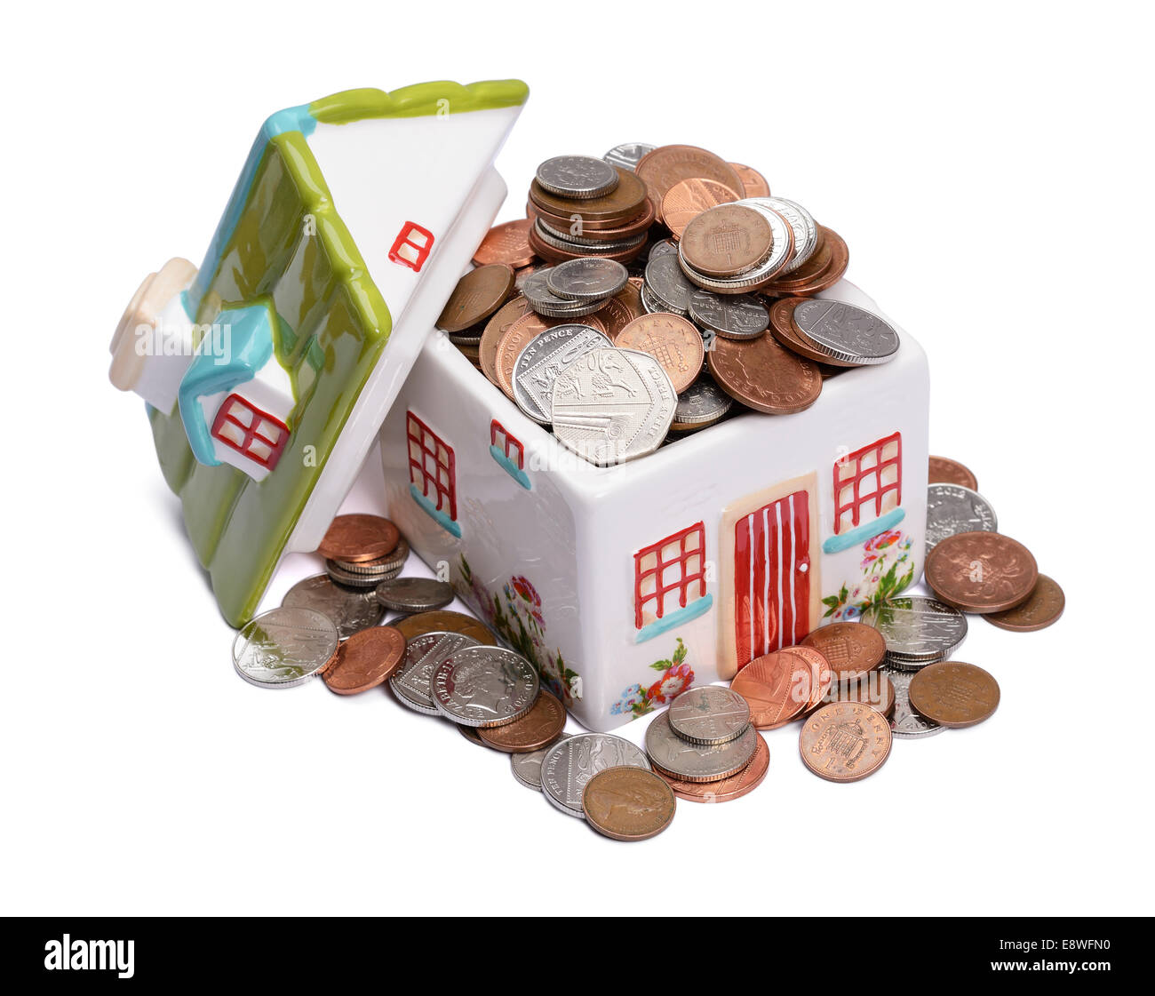Ceramic house model filled with money Stock Photo
