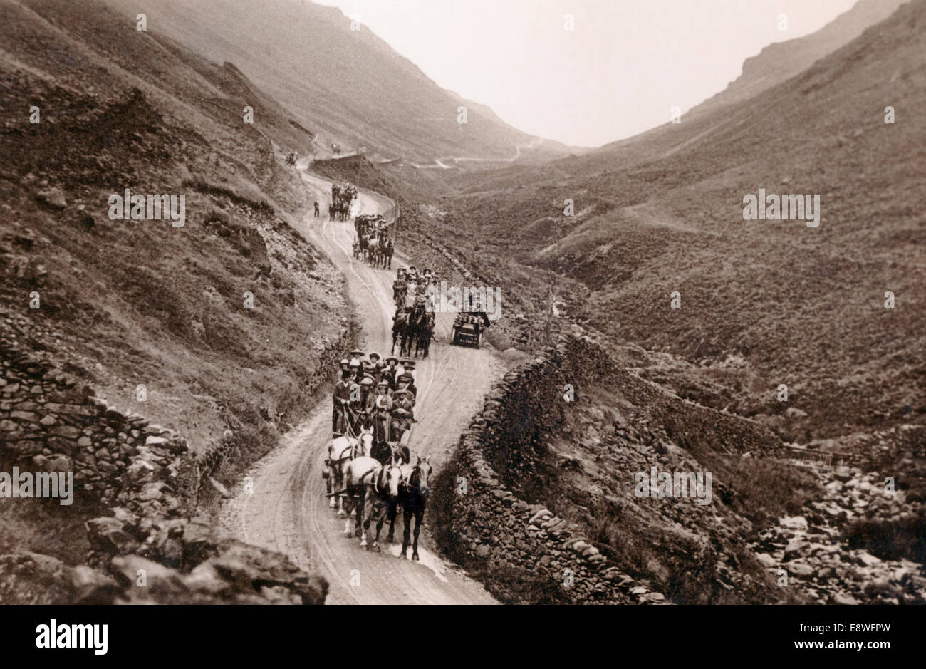 Travellers in horse drawn coaches and wagons with early motor cars on the Kirkstone Pass, Lake District, UK, about 1900 Stock Photo