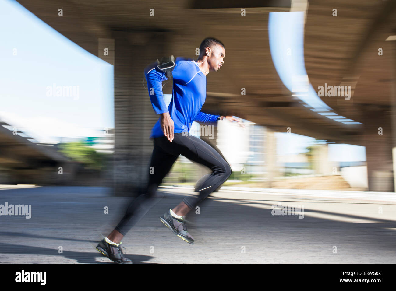 Man running through city streets Stock Photo