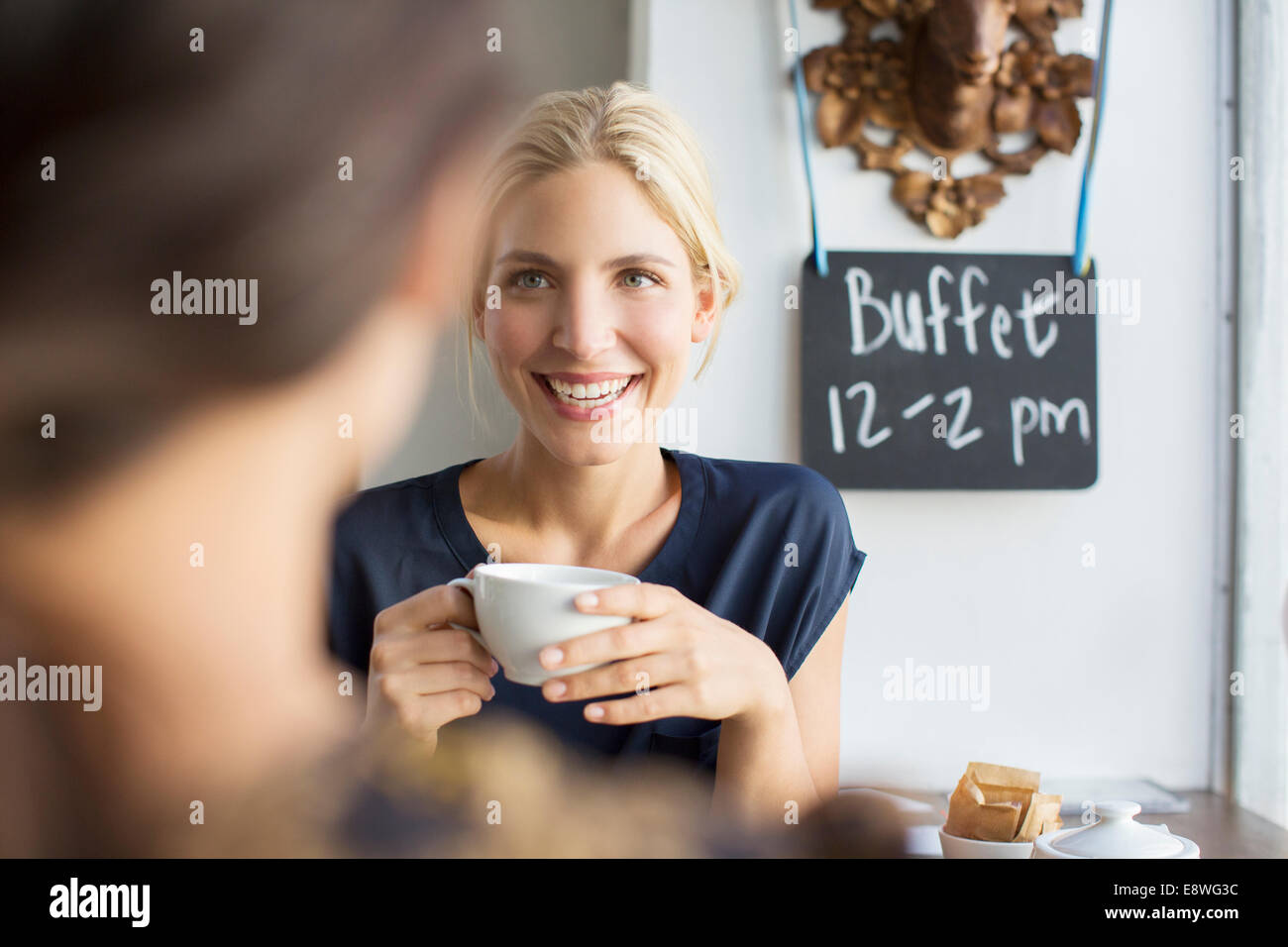 Women having coffee together in cafe Stock Photo