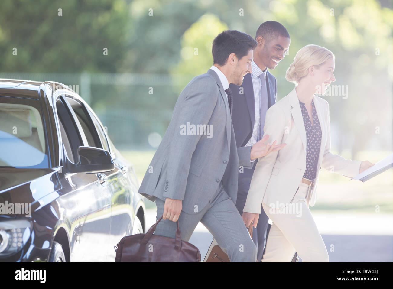 Business people walking together on city street Stock Photo