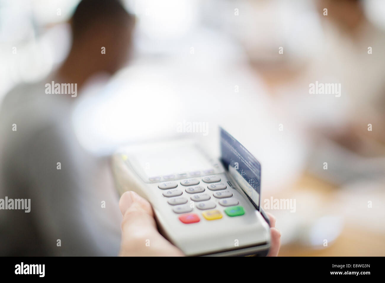 Credit card being swiped through payment machine Stock Photo