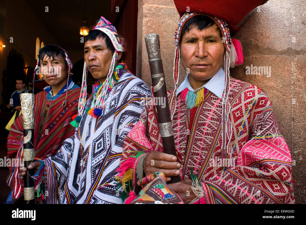 The mountain people dressed in traditional costumes at the door of the church of Pisac Sunday market day. Pisac. Sacred Valley. Stock Photo