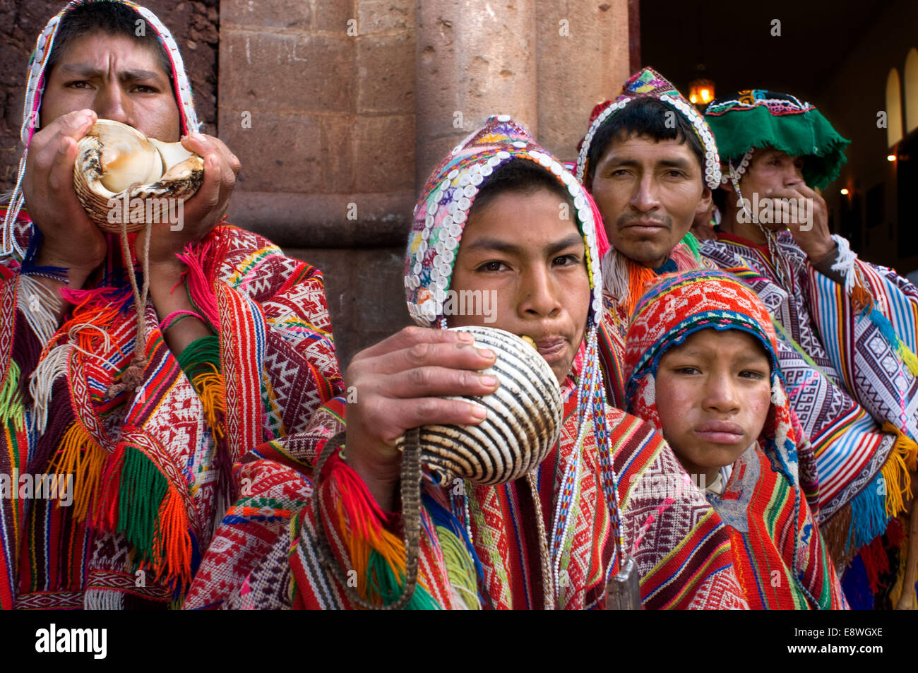 The mountain people dressed in traditional costumes at the door of the church of Pisac Sunday market day. Pisac. Sacred Valley. Stock Photo