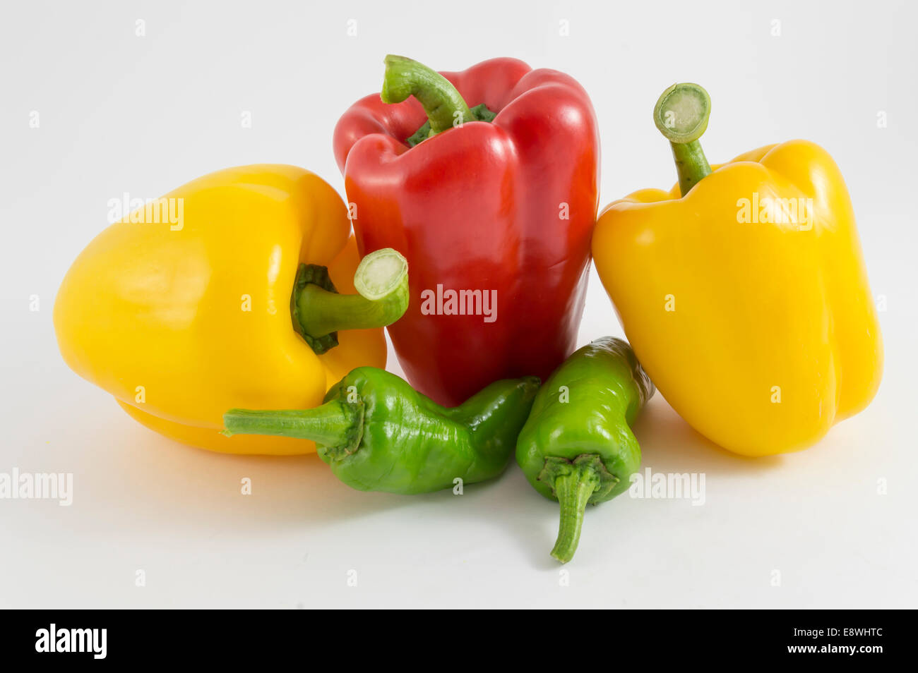 red peppers, green and yellow on a white background Stock Photo - Alamy