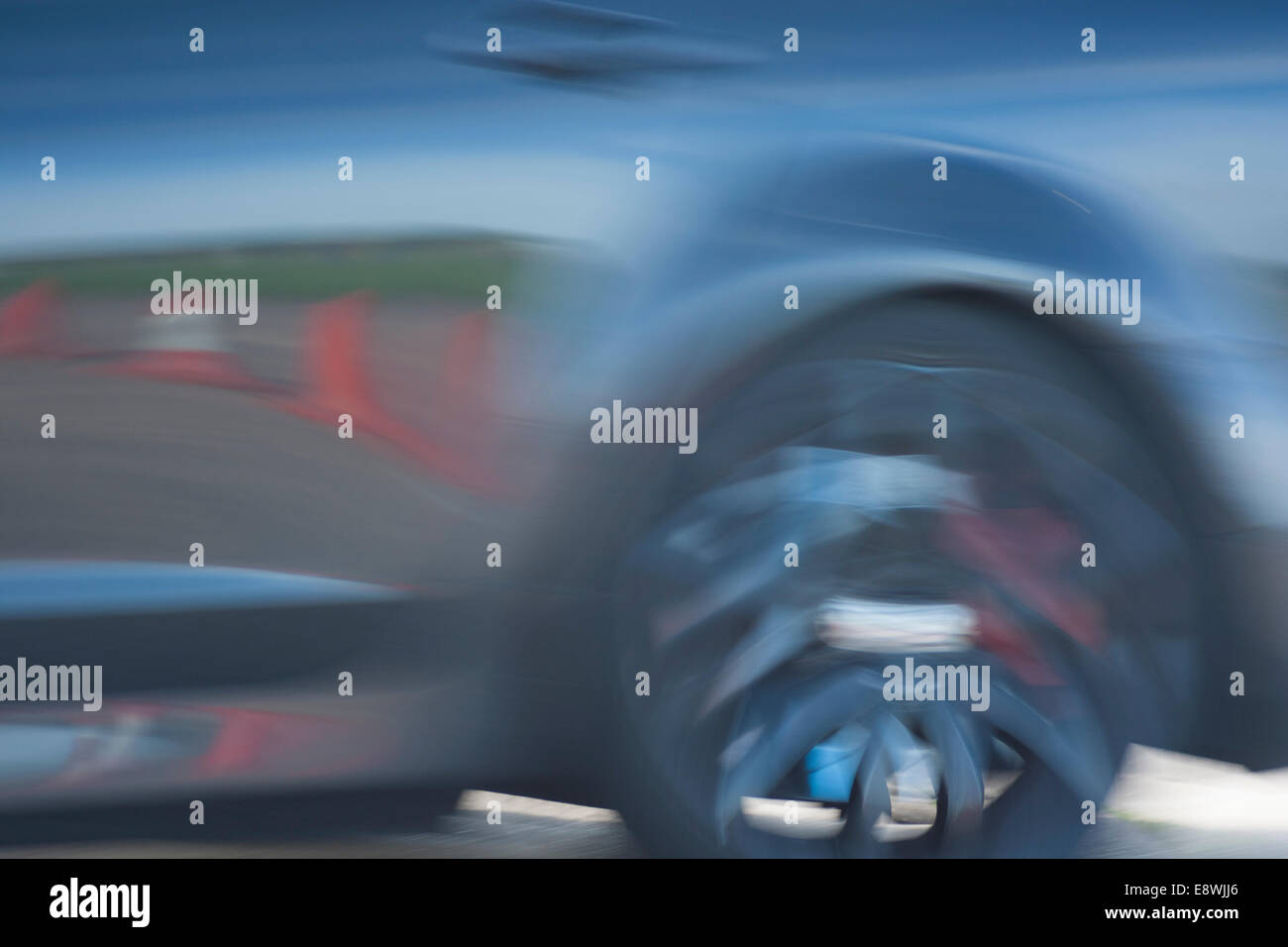 Blurred racing car wheel moving fast Stock Photo Alamy