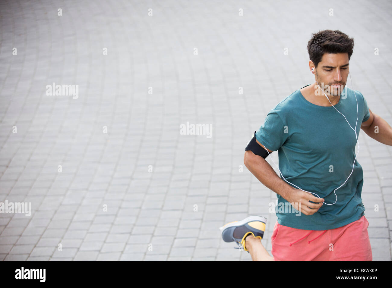 Man running through city streets Stock Photo