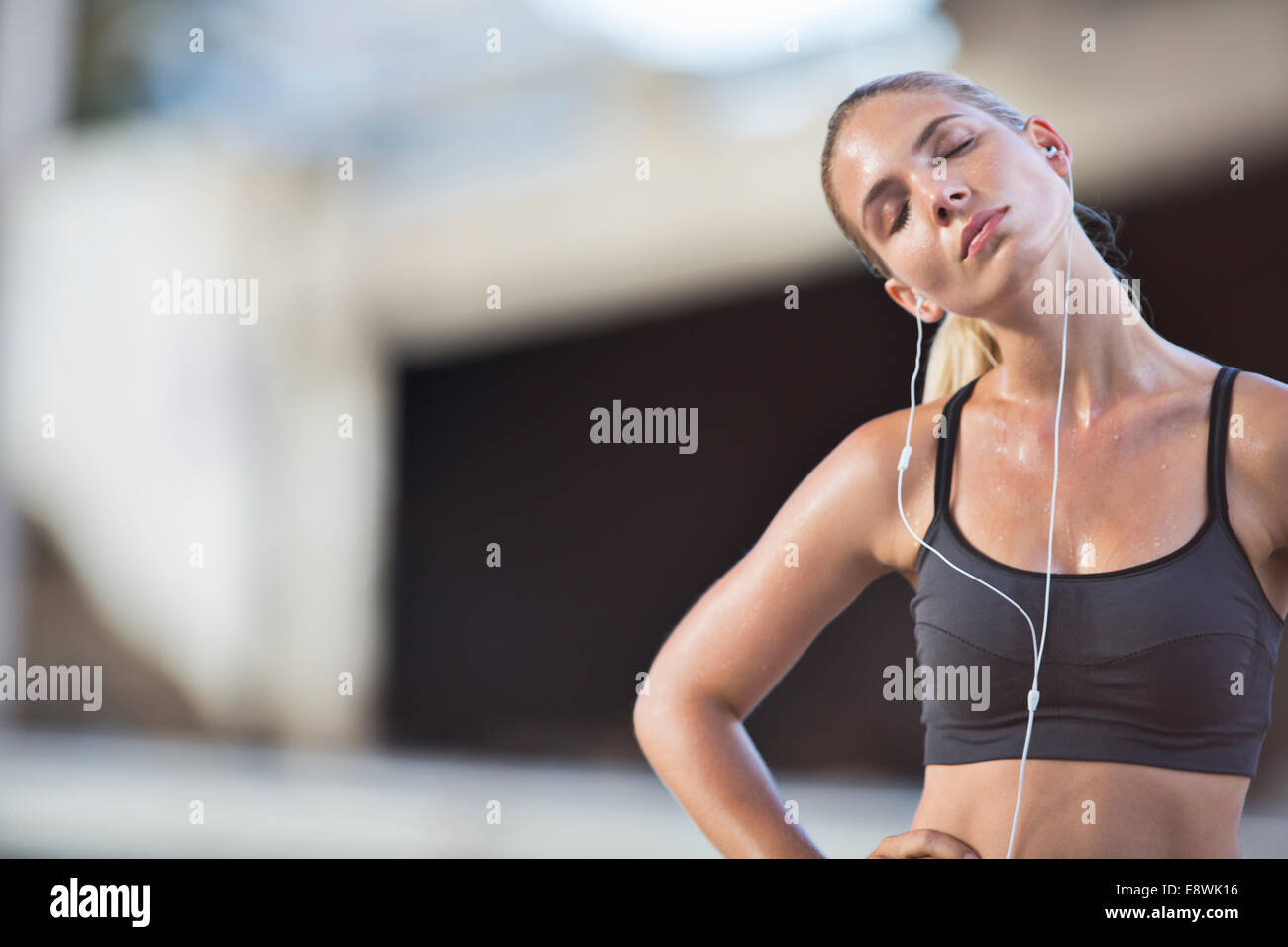 Woman stretching with eyes closed after exercise Stock Photo
