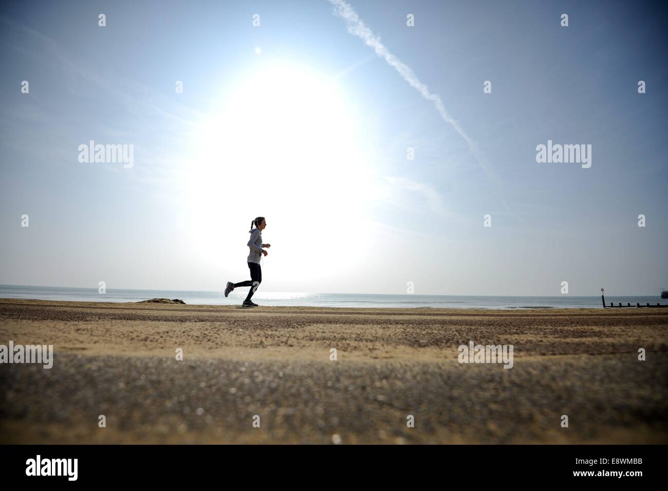 A woman is seen running along the sea front in Bournemouth, England on March 12 2014. Stock Photo