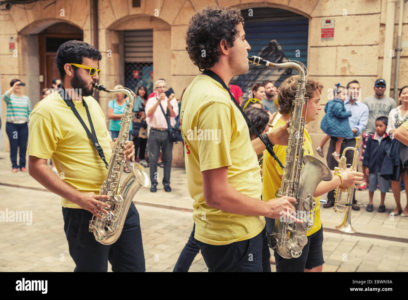 TARRAGONA, SPAIN - AUGUST 16, 2014: Young musicians with saxophones in the street of Tarragona, Catalonia, Spain Stock Photo