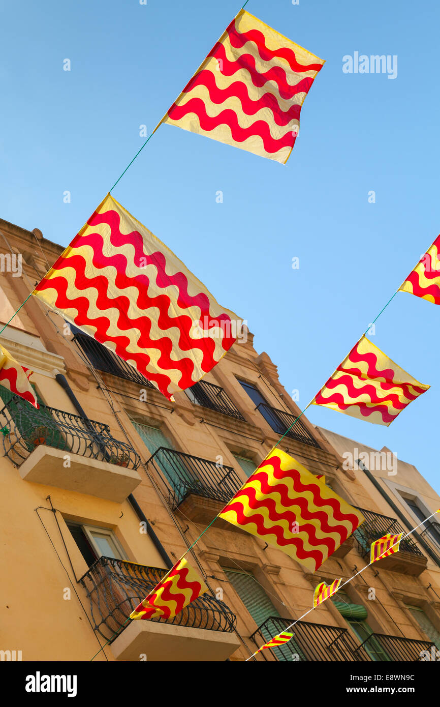 Flags of Tarragona town and Catalonia hanging over street Stock Photo