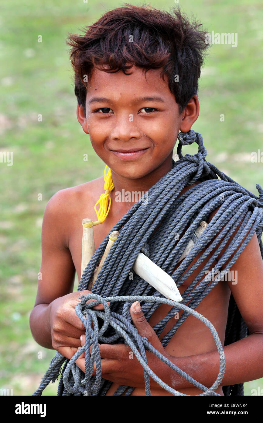 Young herdsman boy with rope over his shoulder. Takeo province, Cambodia, Asia Stock Photo