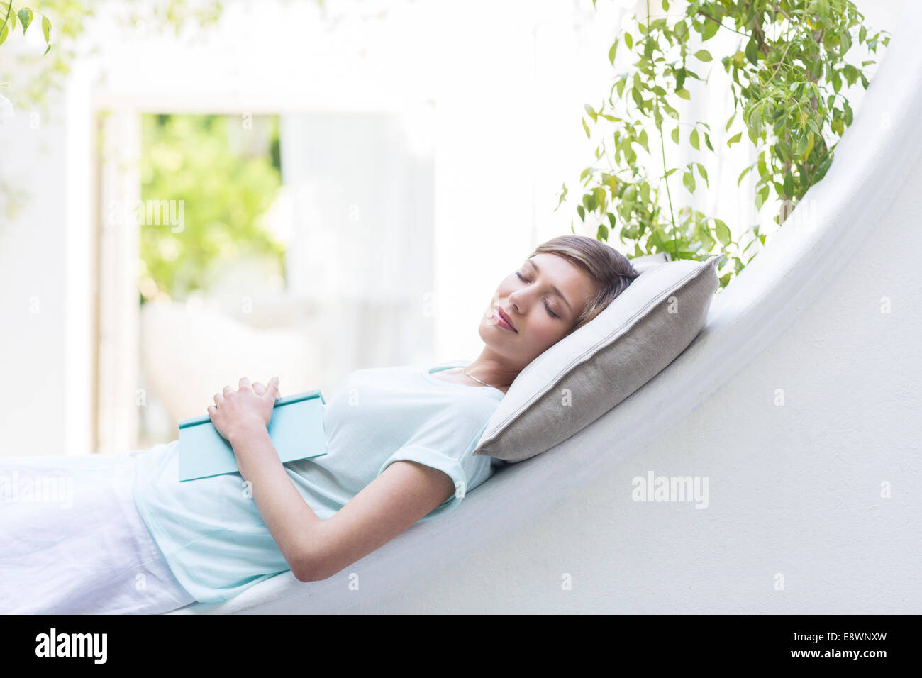 Woman relaxing on pillow outdoors Stock Photo