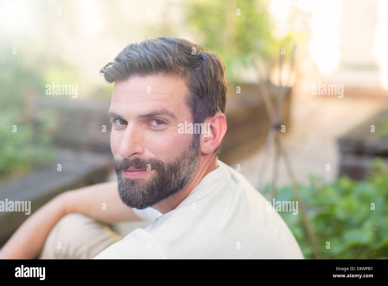 Close up of man smiling in backyard Stock Photo