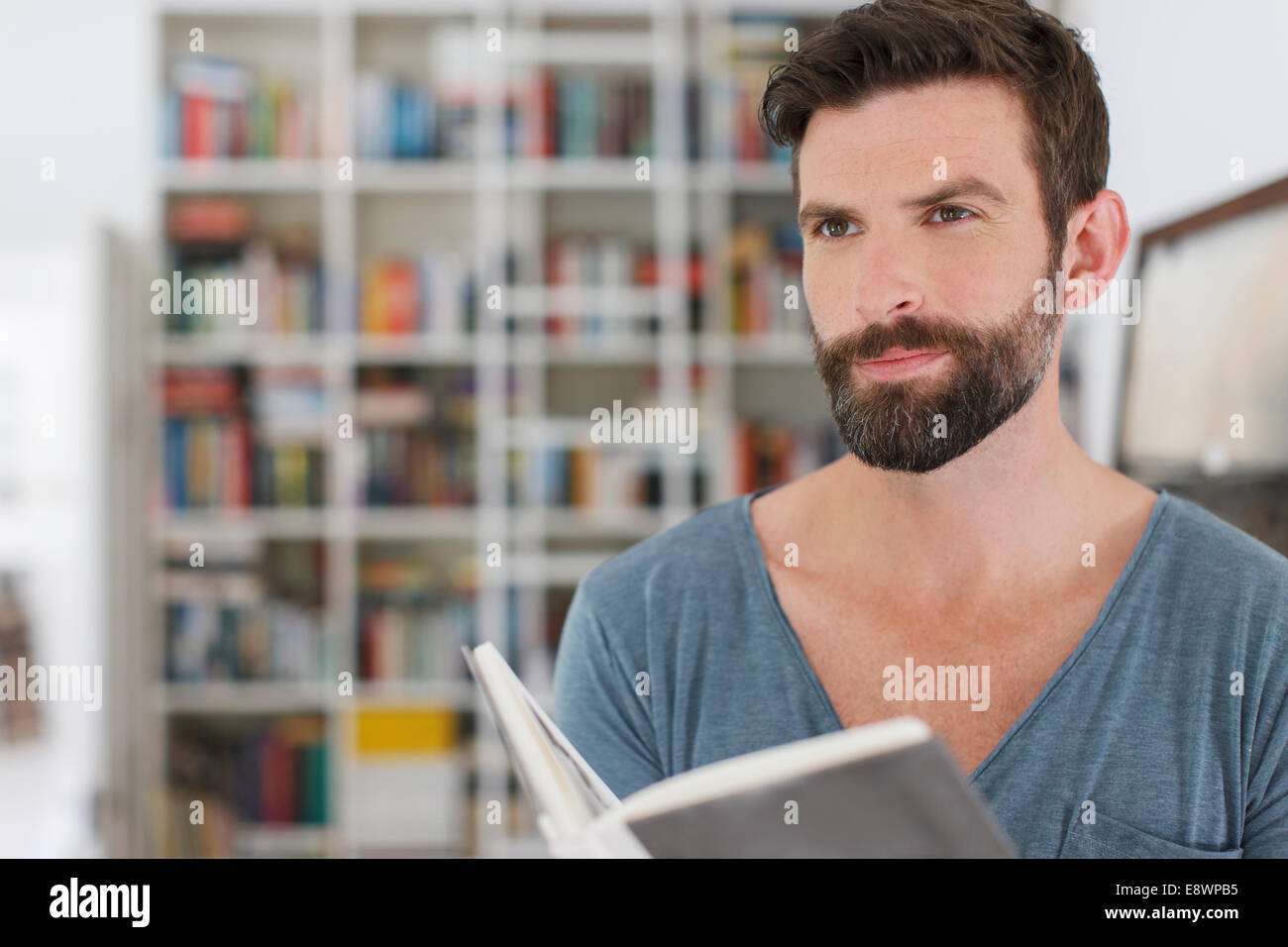 Man reading book in living room Stock Photo
