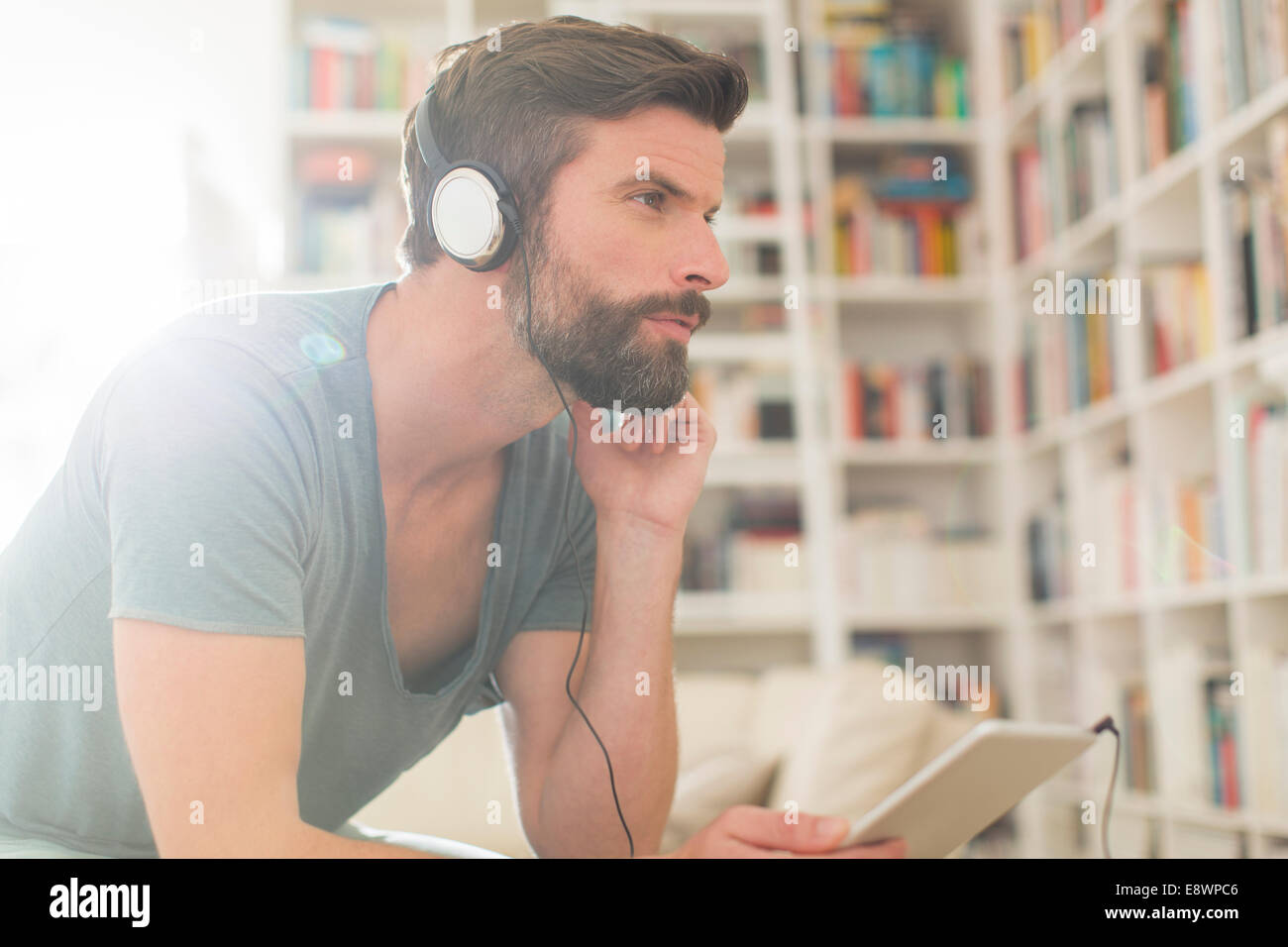 Man listening to music in living room Stock Photo