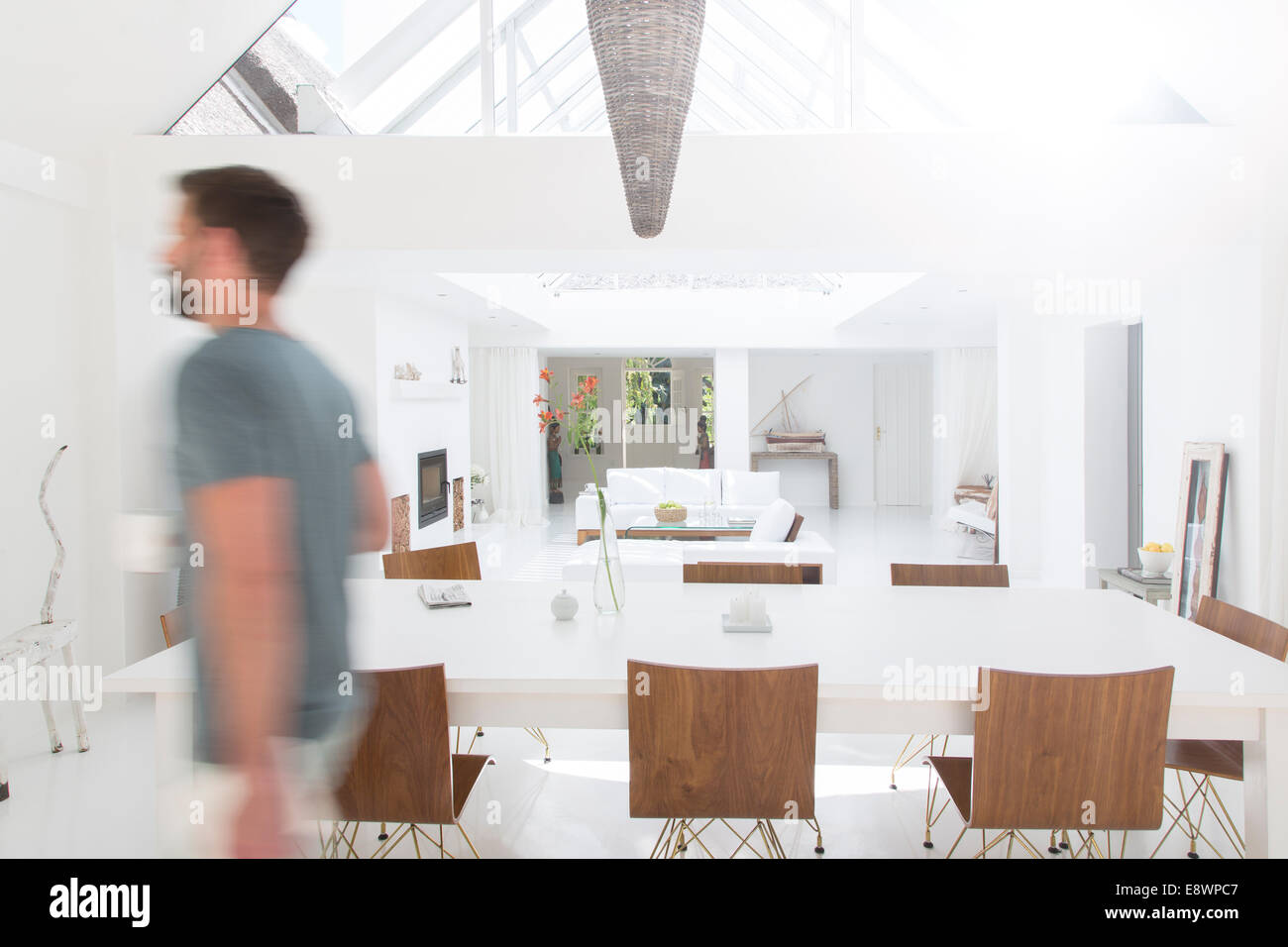 Blurred view of man walking in modern dining room Stock Photo