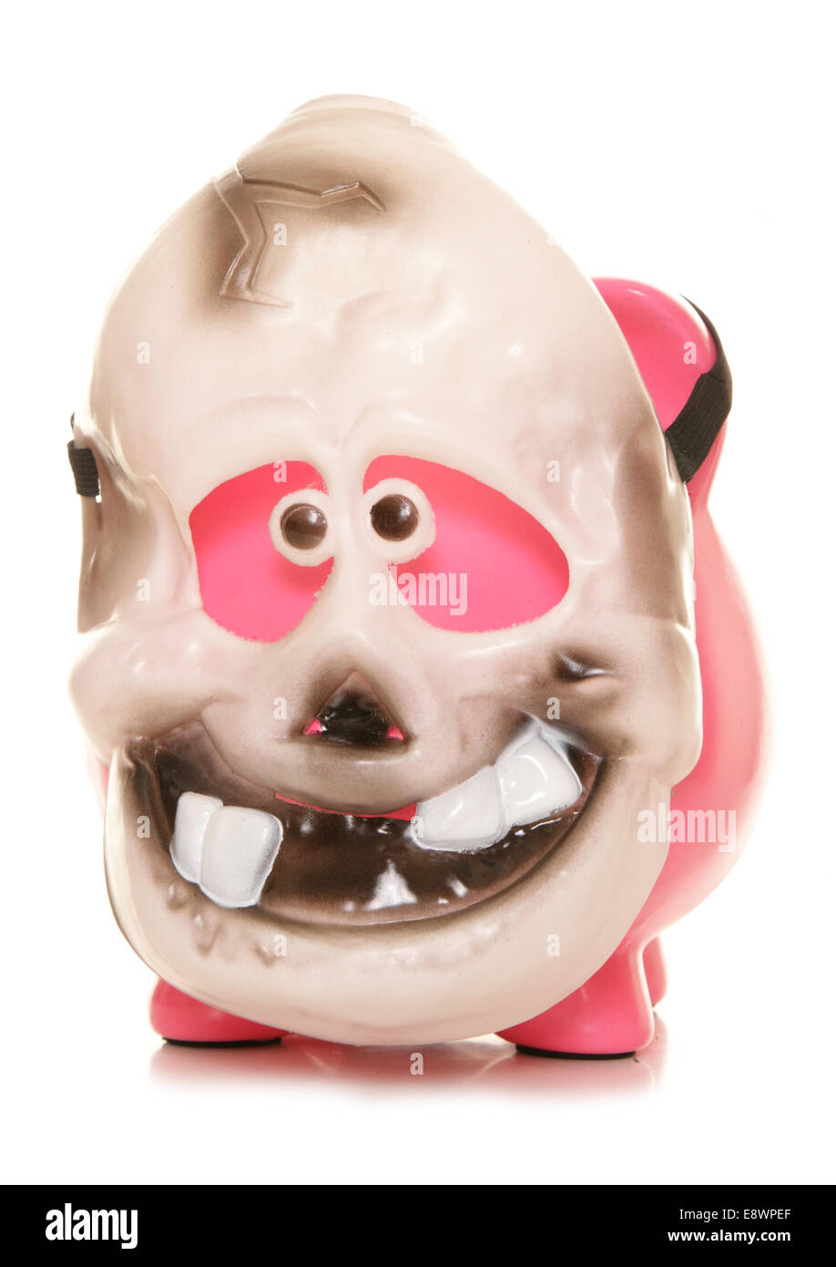 Piggy bank wearing a skeleton halloween mask cutout Stock Photo