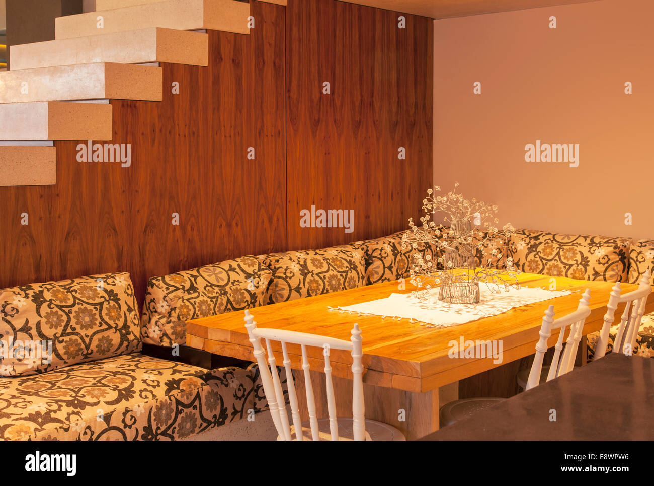 Sofa surrounding dining room table in modern house Stock Photo
