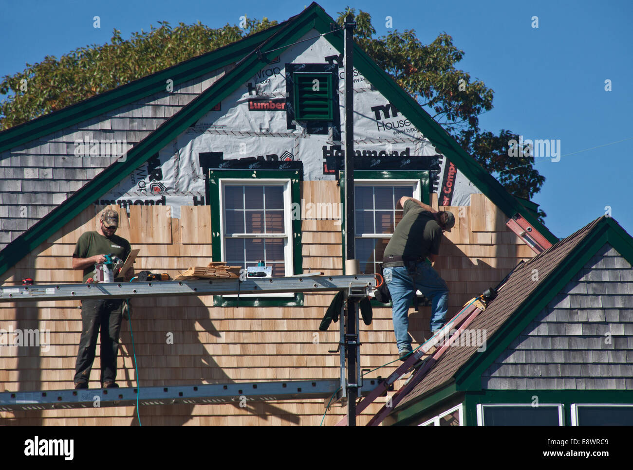 Men shingling a house in New harbor, Maine Stock Photo