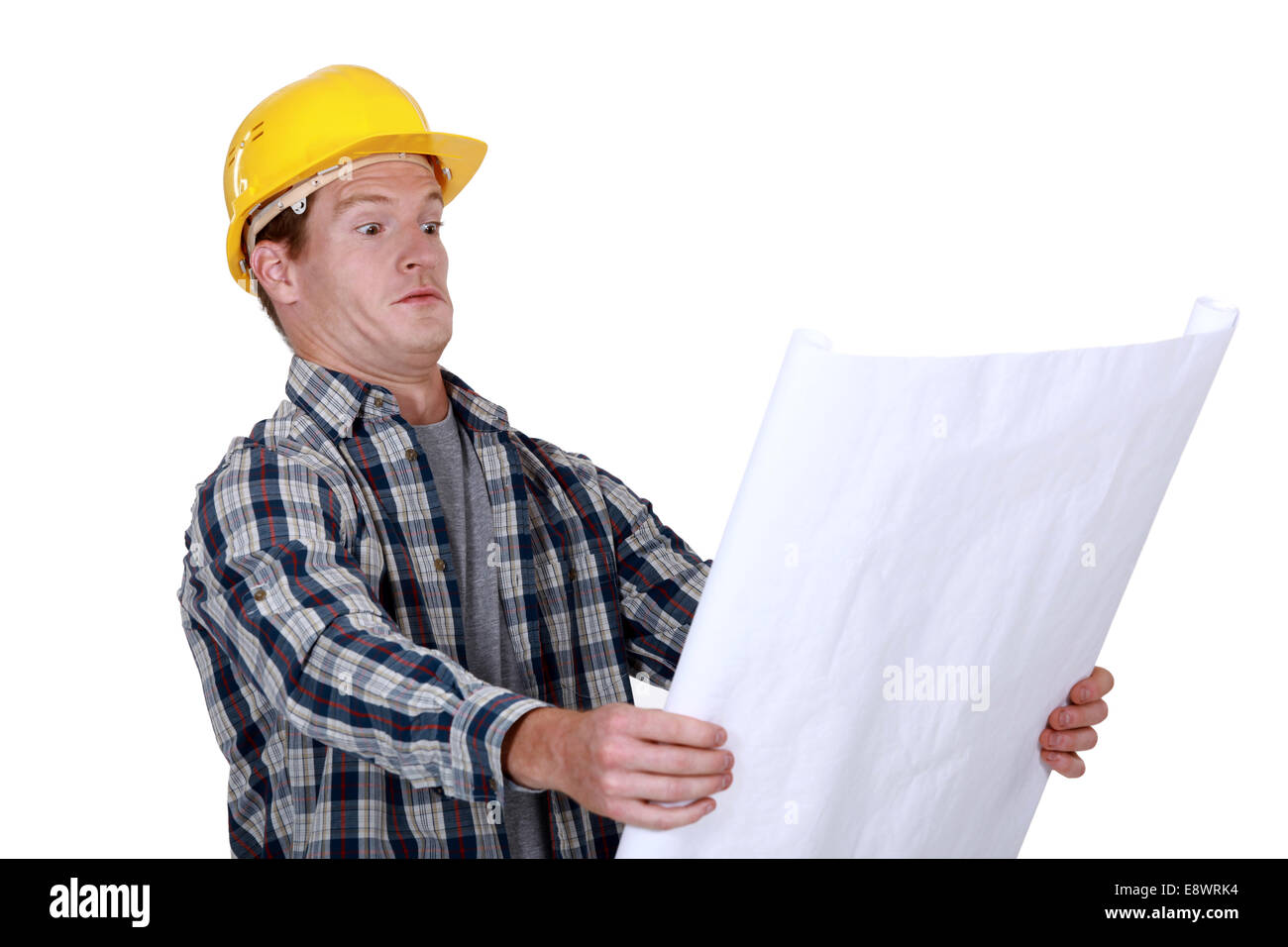 craftsman holding a blueprint and looking very surprised Stock Photo ...