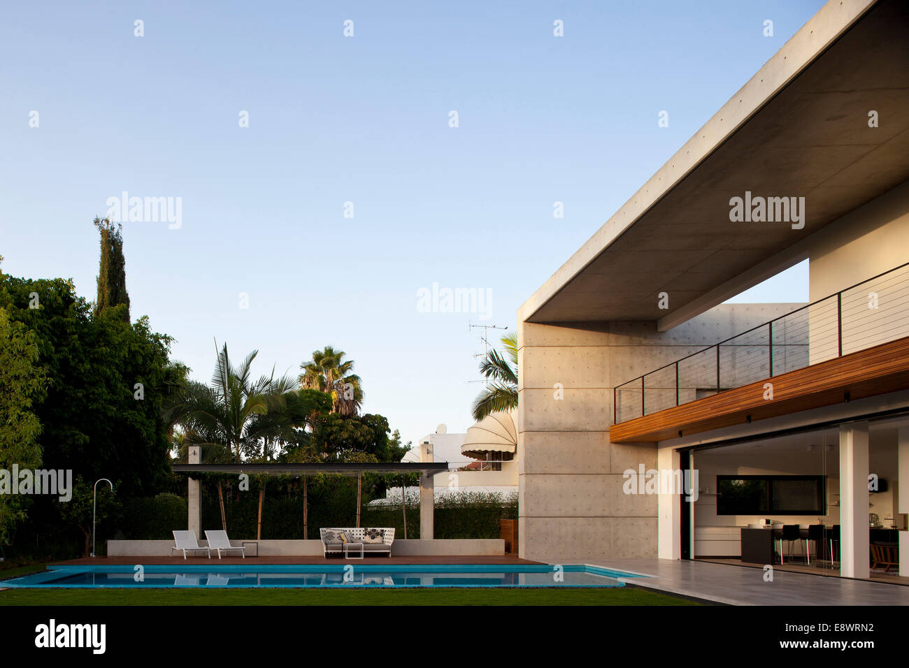 Double height balcony facade and swimming pool of D House, Israel