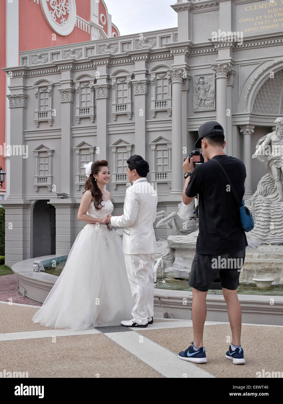 Wedding photographer. Venice styled location used as a background for a Thai wedding shoot with bride, groom and working photographer Thailand Asia Stock Photo