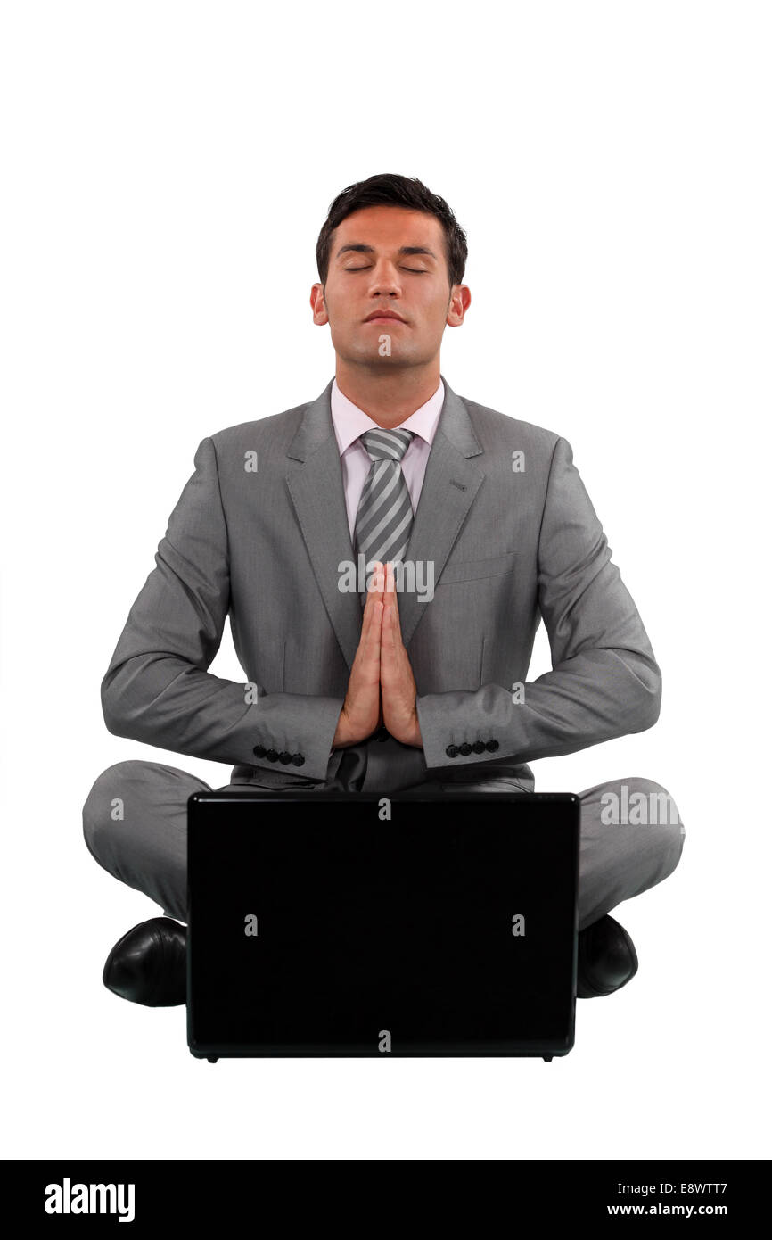 Calm businessman sat in yoga Stock Photo - Alamy