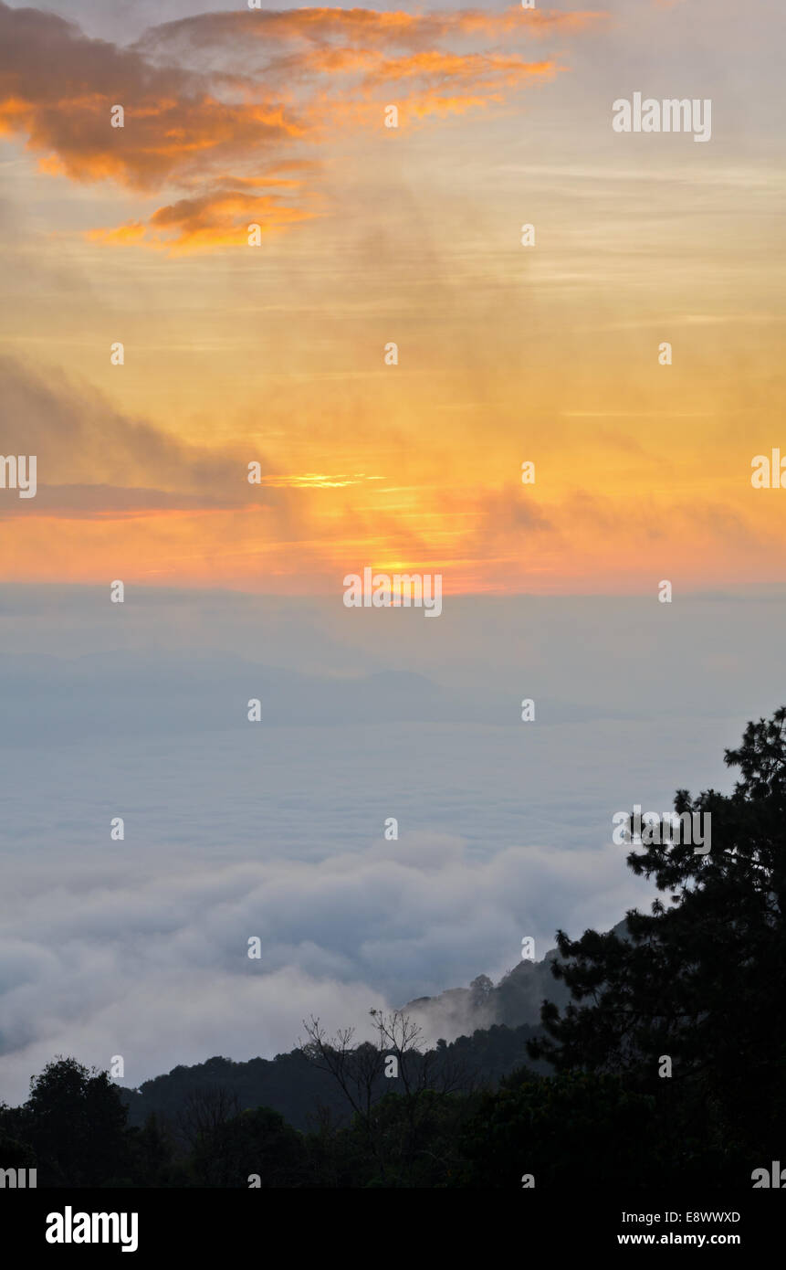 Colorful sunrise above the clouds from high mountain at viewpoint Huai Nam Dang national park in Chiang Mai and Mae Hong Son pro Stock Photo