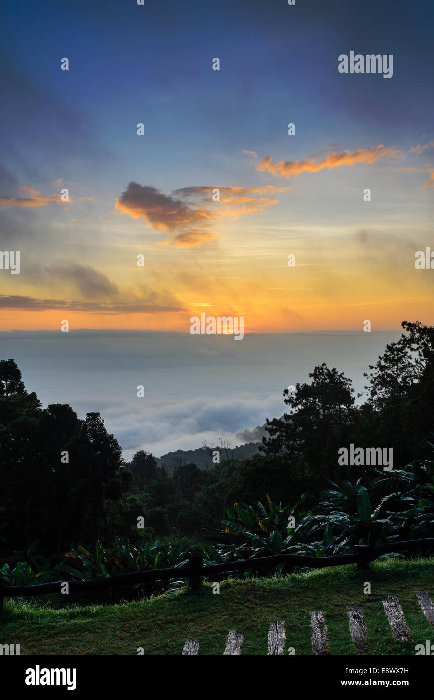 Colorful sunrise above the clouds from high mountain at viewpoint Huai Nam Dang national park in Chiang Mai and Mae Hong Son pro Stock Photo