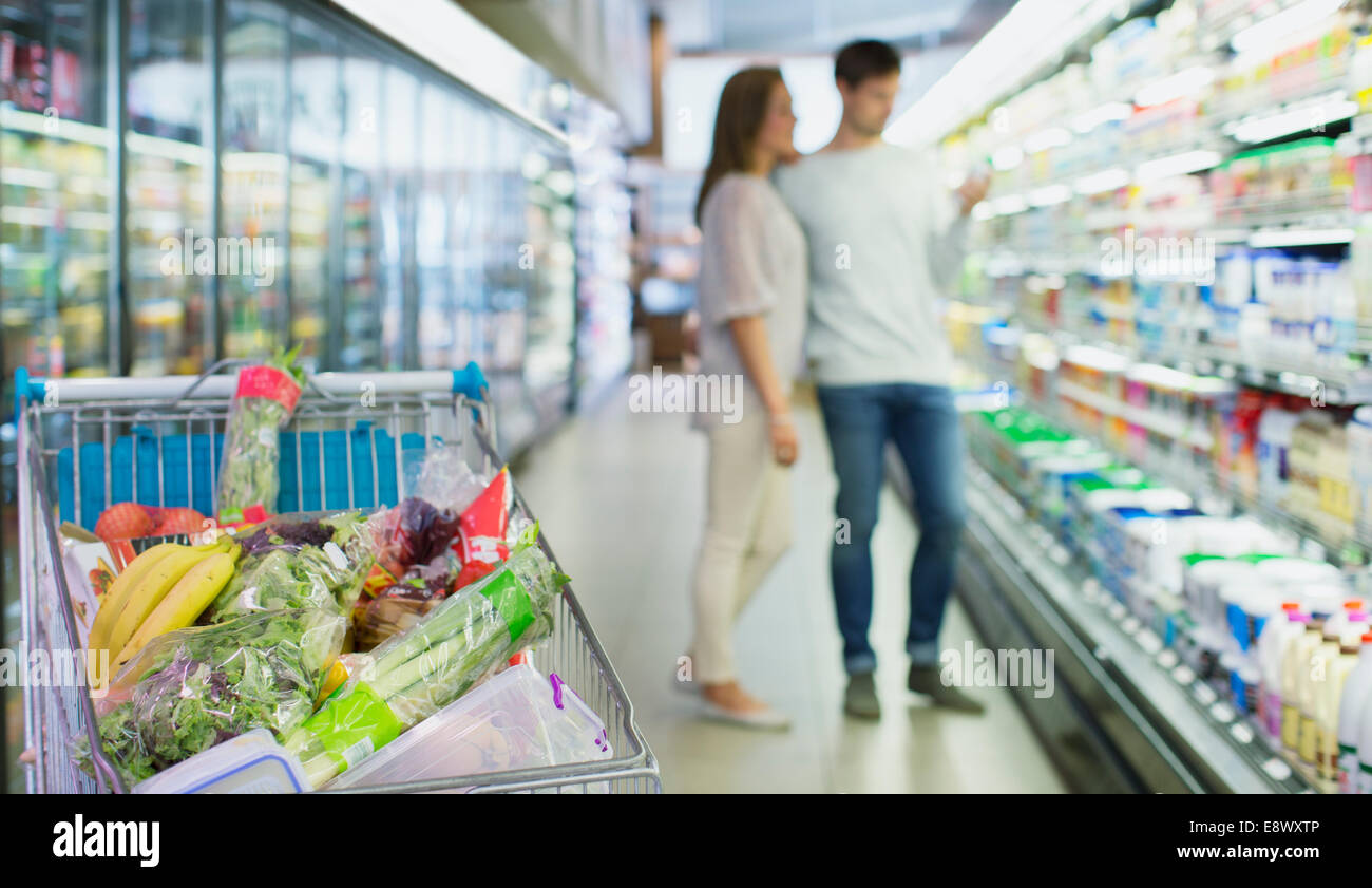 Defocussed view of couple shopping in grocery store Stock Photo