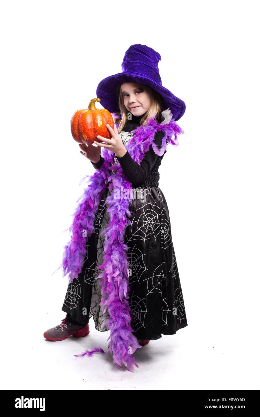 Portrait of little girl in witch costume with pumpkin. Halloween ...