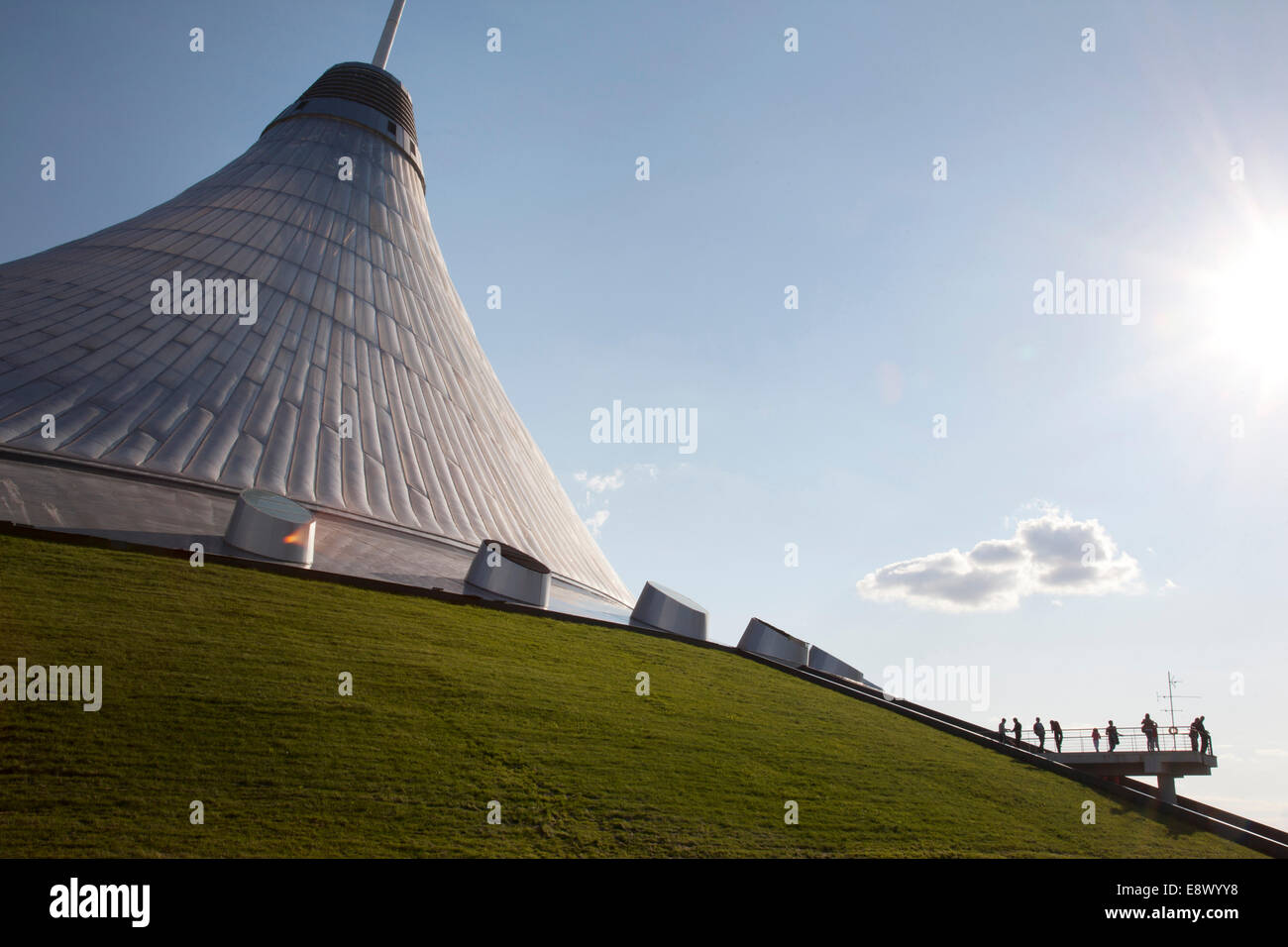 Pedestrians are dwarfed by the futuristic Khan Shatyry entertainment center at dusk, Astana, Kazakhstan Stock Photo