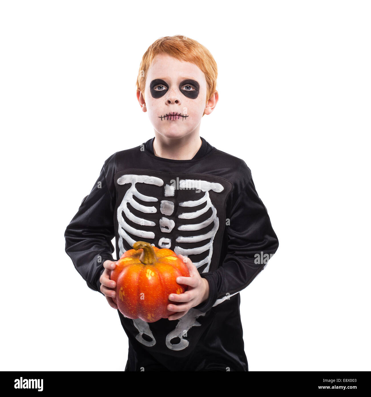 Portrait of little red haired boy wearing halloween skeleton costume ...