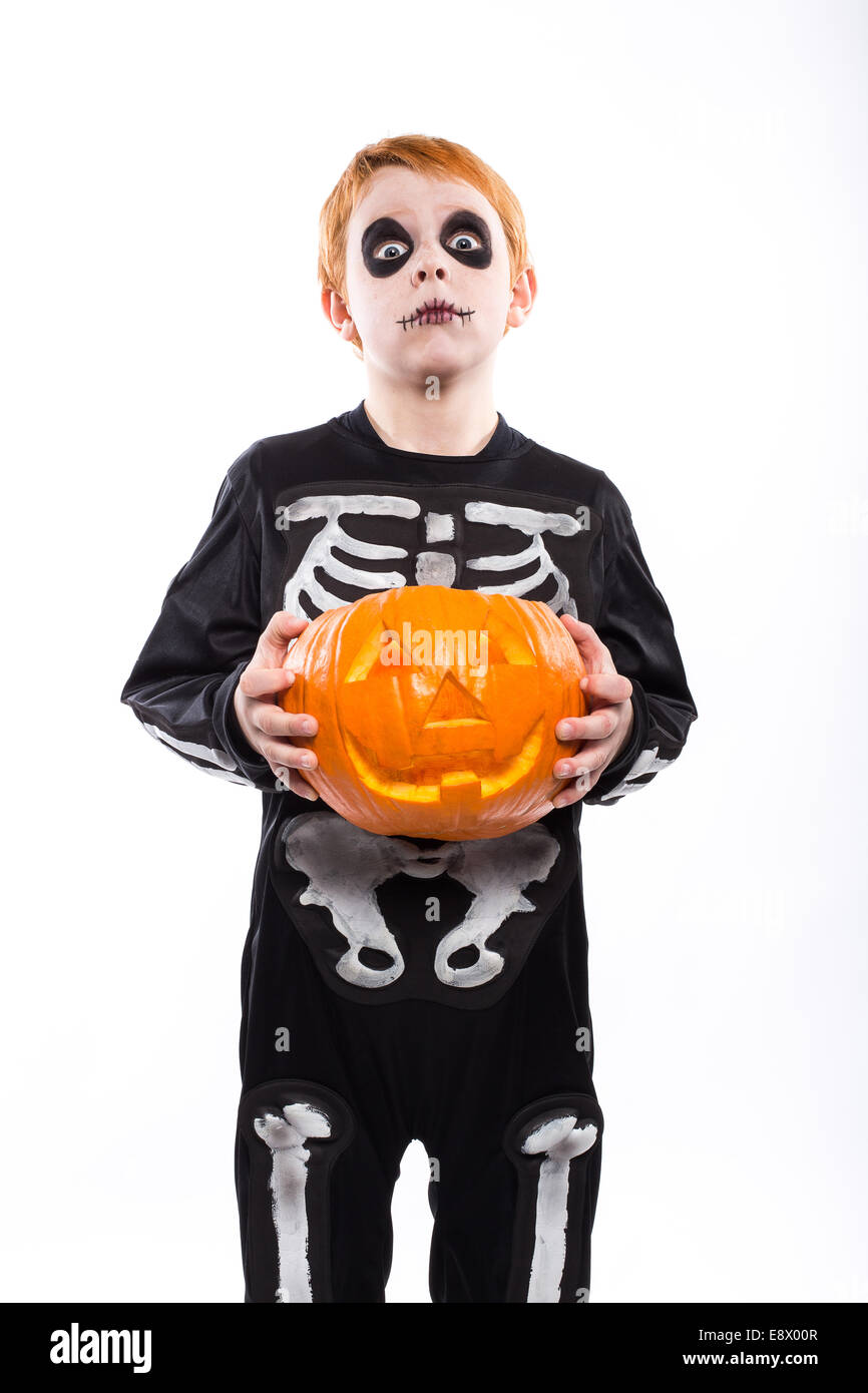 Red haired boy in skeleton costume holding a pumpkin. Halloween Stock ...