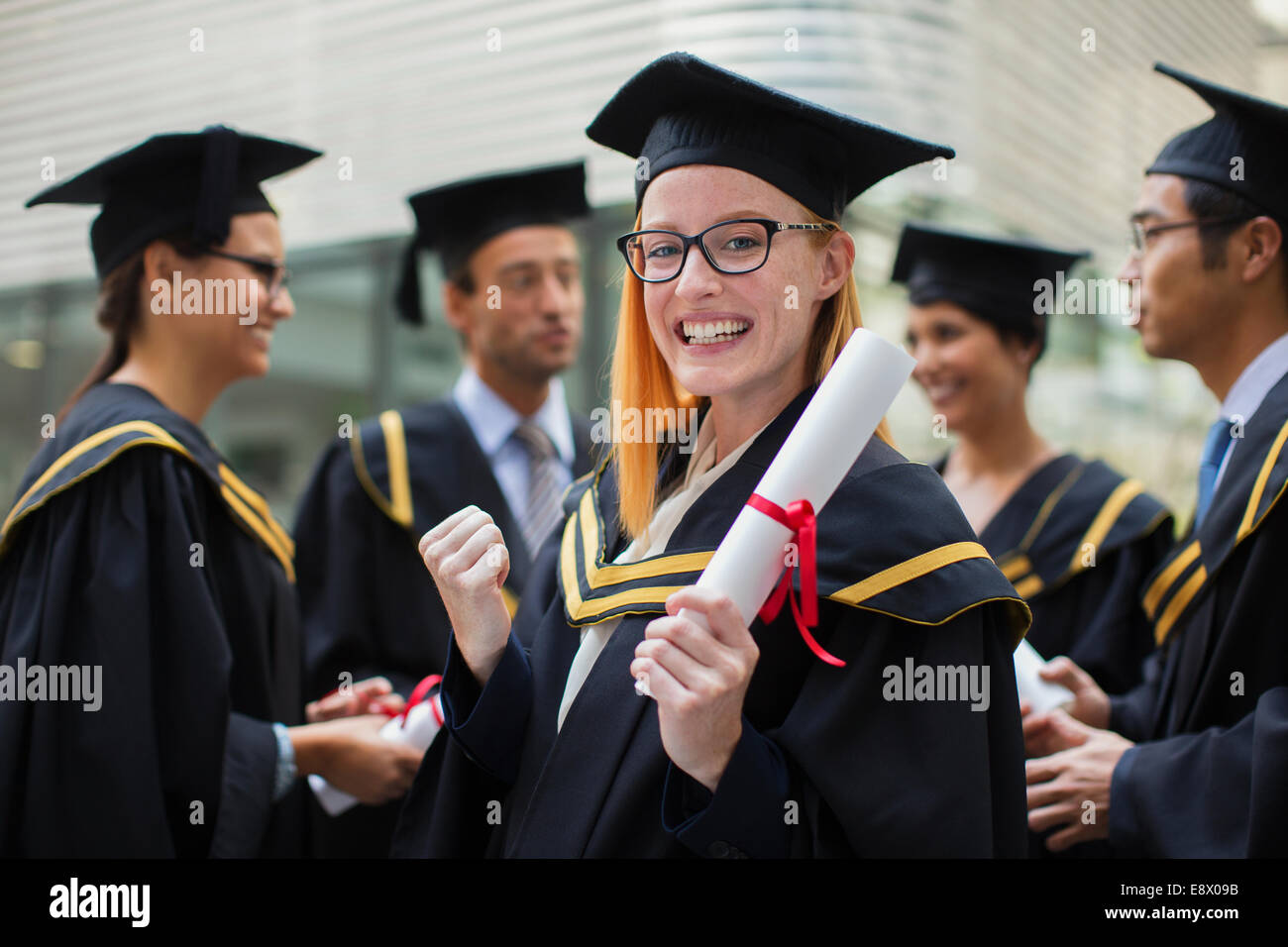 Student in cap and gown celebrating Stock Photo