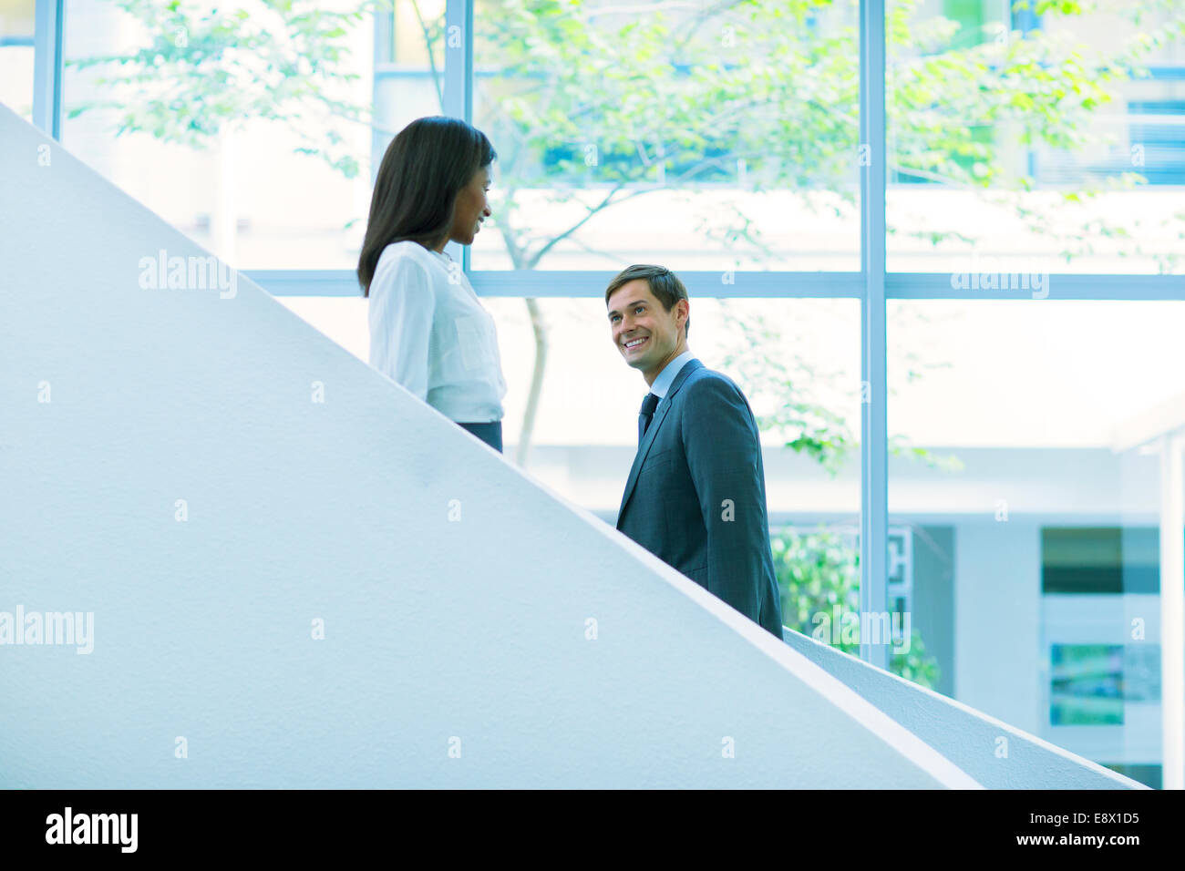 Business people walking up and down the office building stairs Stock Photo