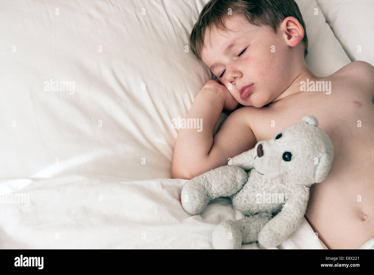 Young Boy asleep in bed Stock Photo