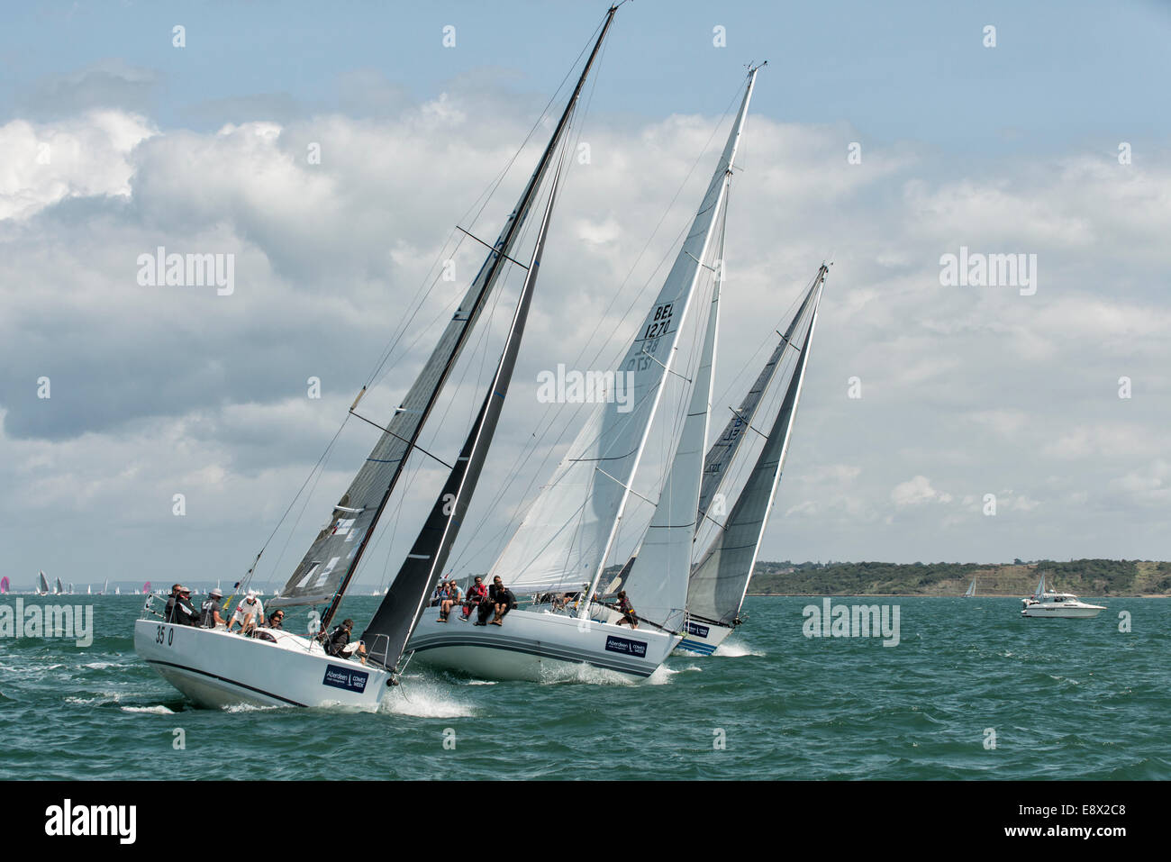 Close racing during Cowes Week Regatta saw these three yachts fighting for position in the Solent in the southern United Kingdom Stock Photo