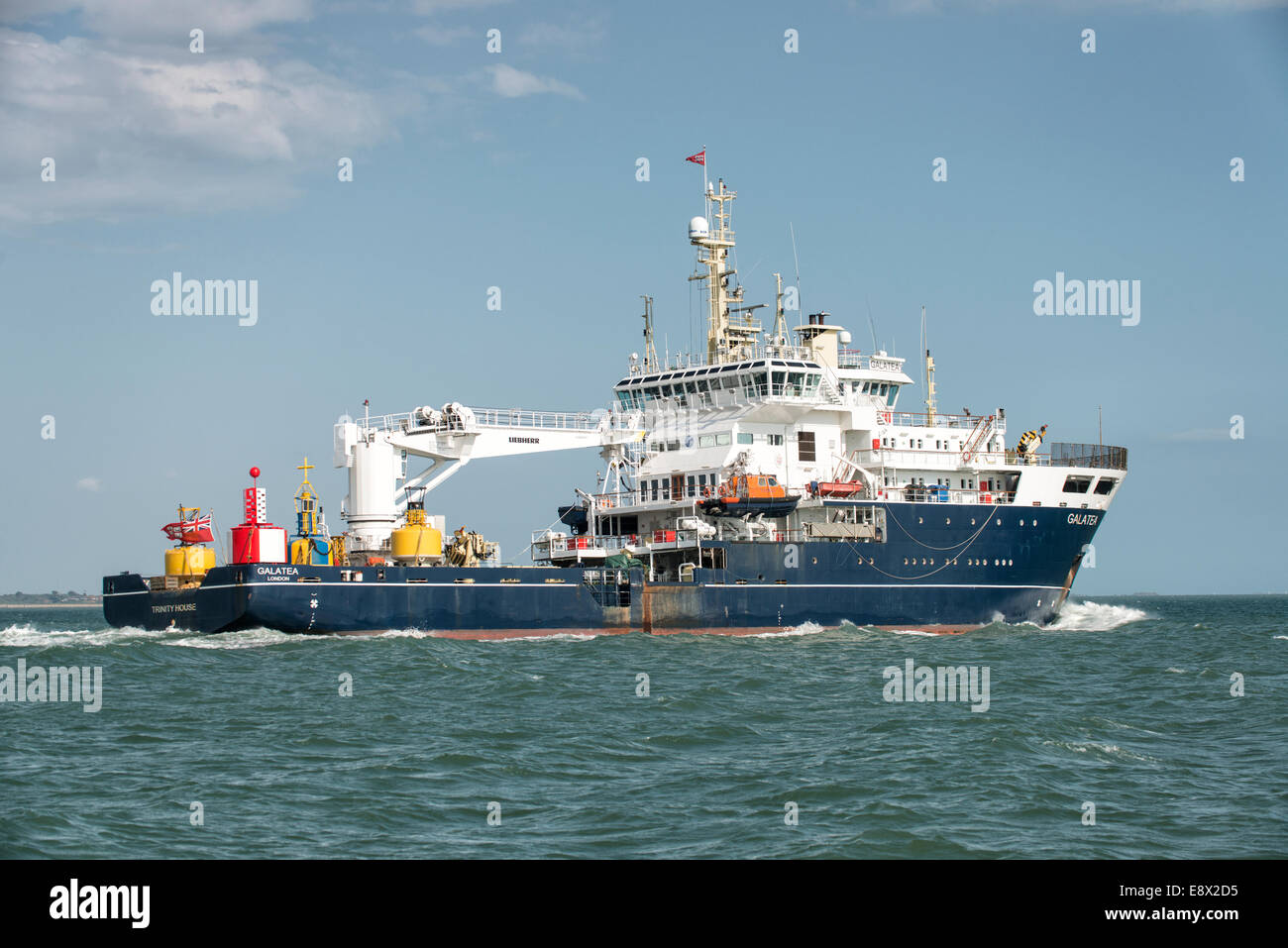 Trinity House multi functional tender Galatea makes her way along the Solent with a selection of maritime buoys onboard. Stock Photo